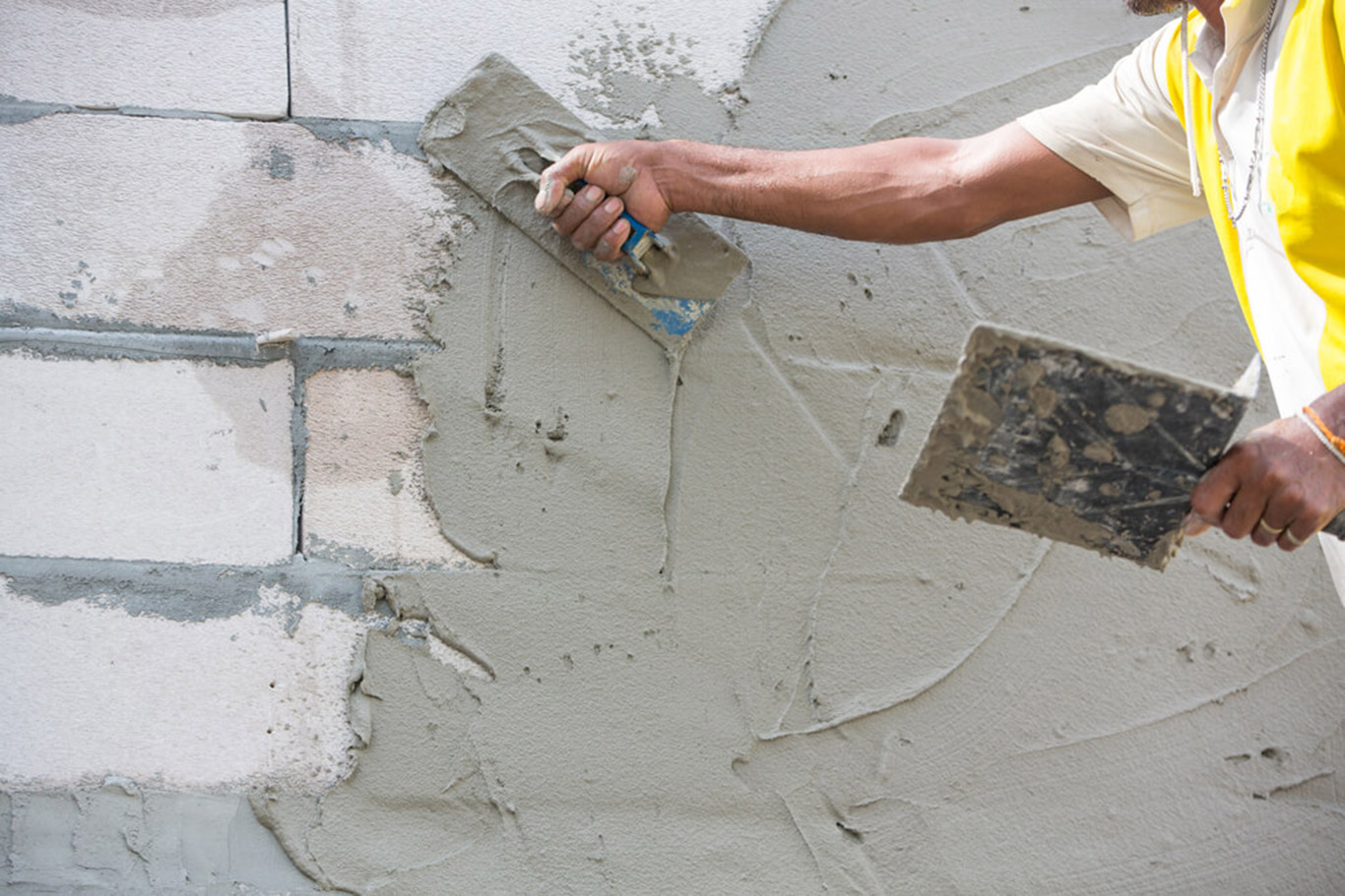 Plastering is used to cover and smoothen brick wall surfaces.