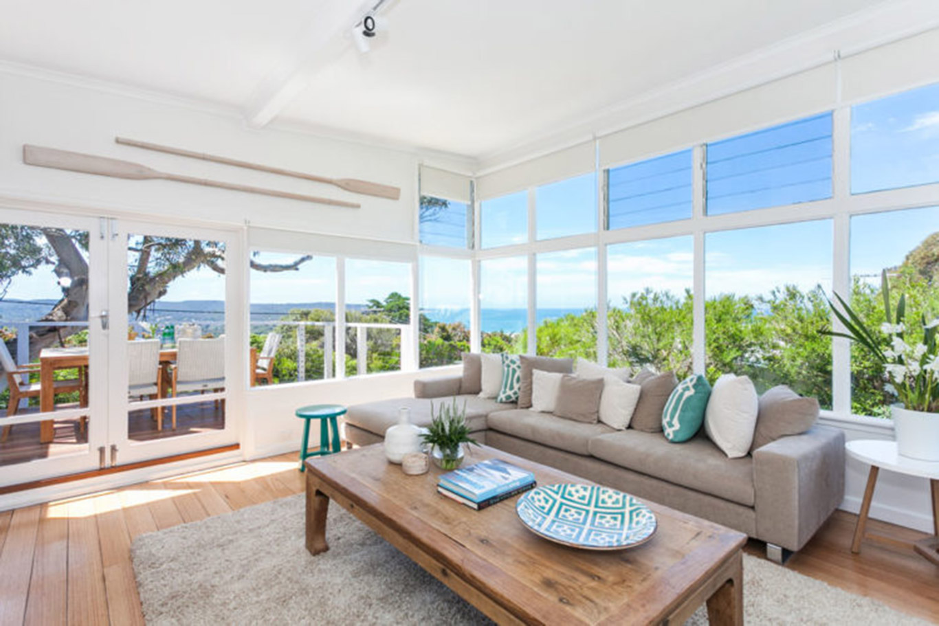 Coastal style design in a brightly lit living room.