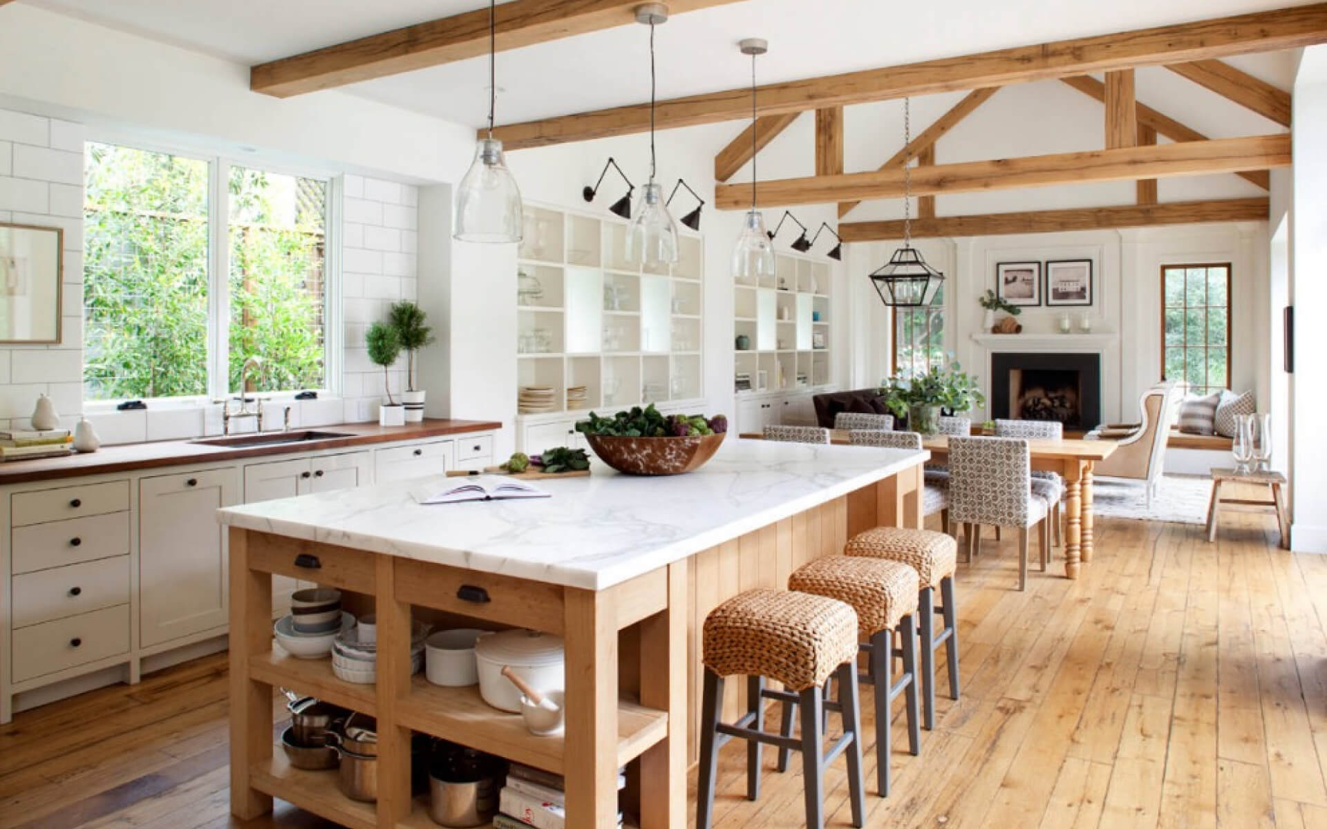 Kitchen interior is built with wood and colored in white tones.