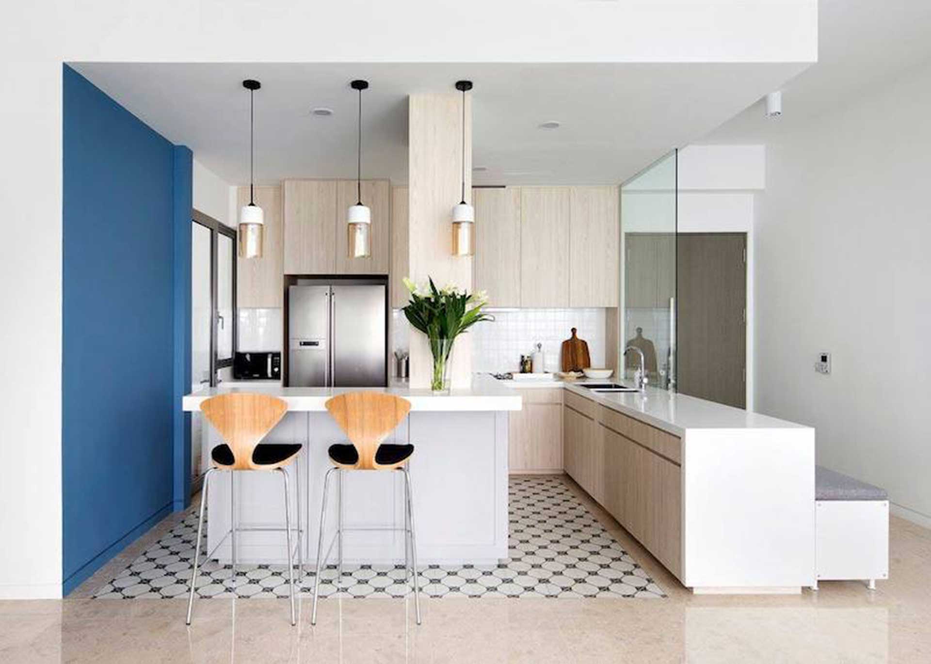 Light neutral wooden cabinetry in an open-concept Contemporary kitchen