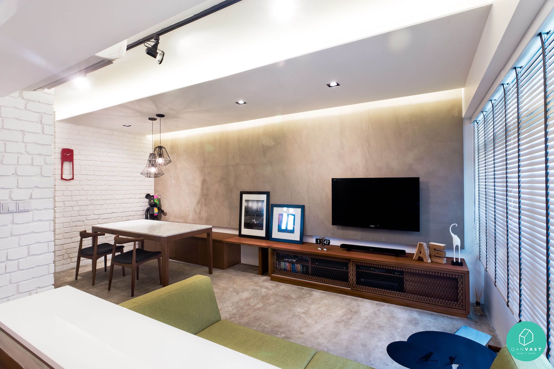 Solid white textured brick tiled wall decorated against the warm wood console table and warm cove lighting