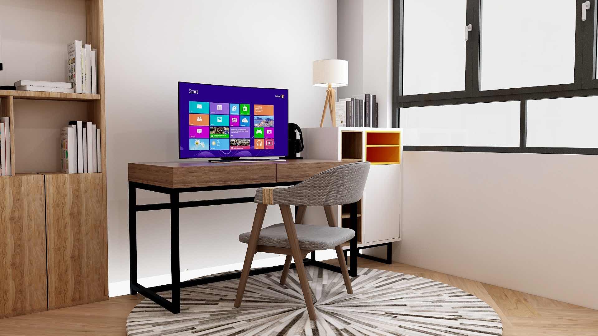 Computer screen on wooden study table with modern chair in a study room