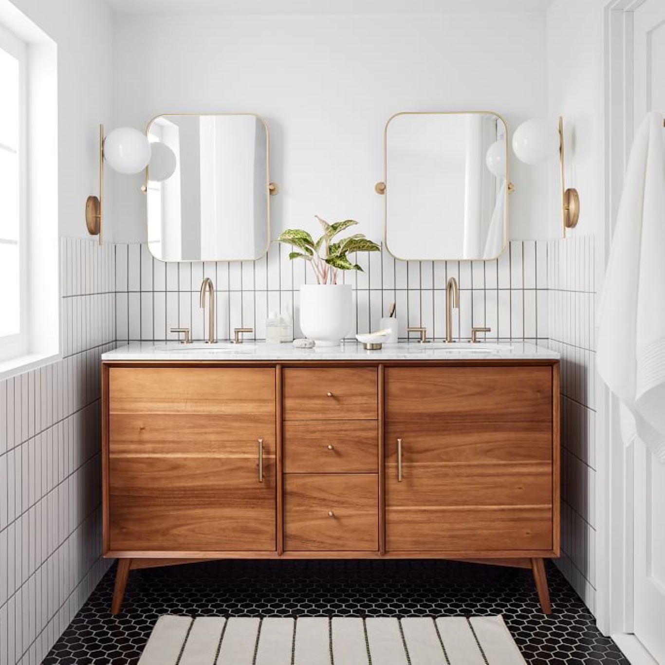 White bathroom matched with wood finishes and a brick walled shower