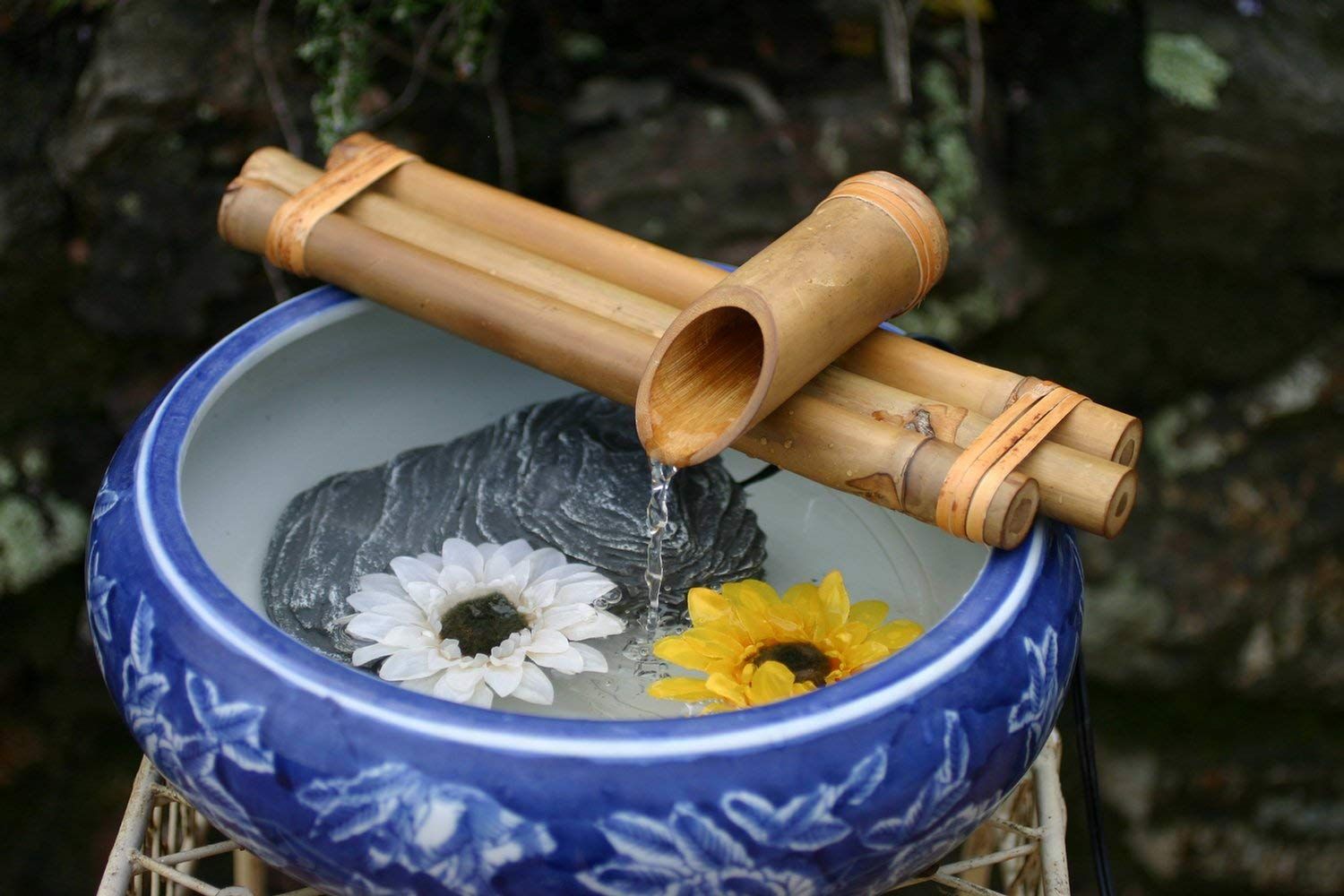 Small bamboo water fountain in a porcelain bowl