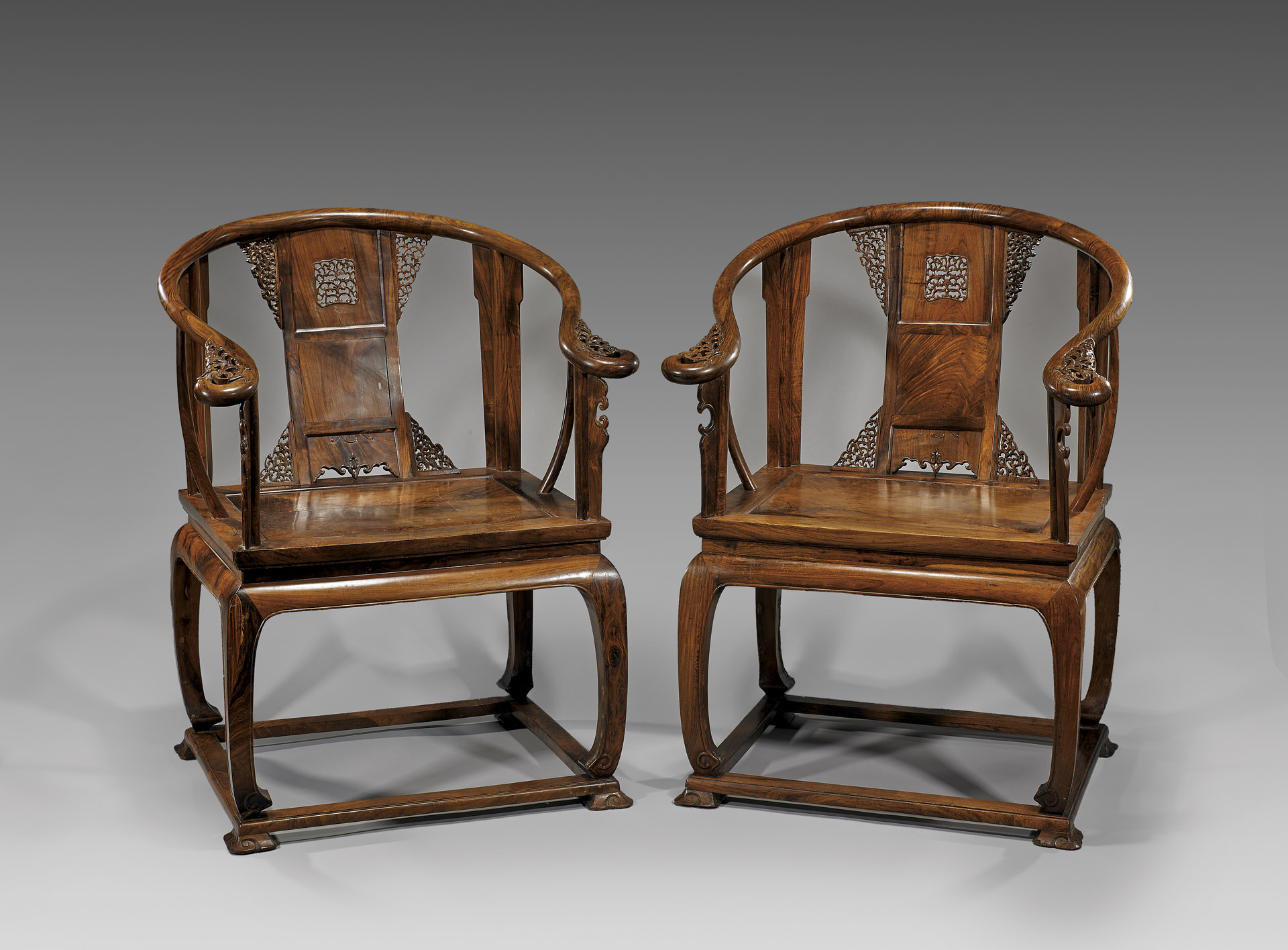 Two elaborately designed Ming Dynasty chairs side-by-side