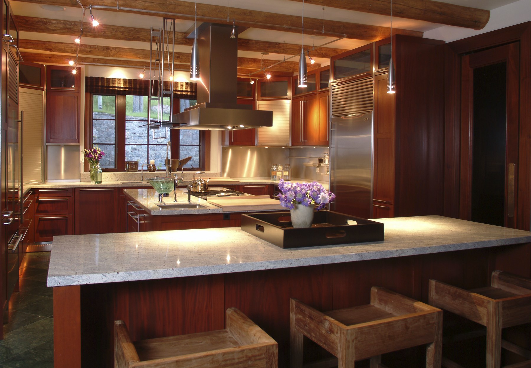 Modern kitchen with red cabinets, marble countertops, and modern appliances