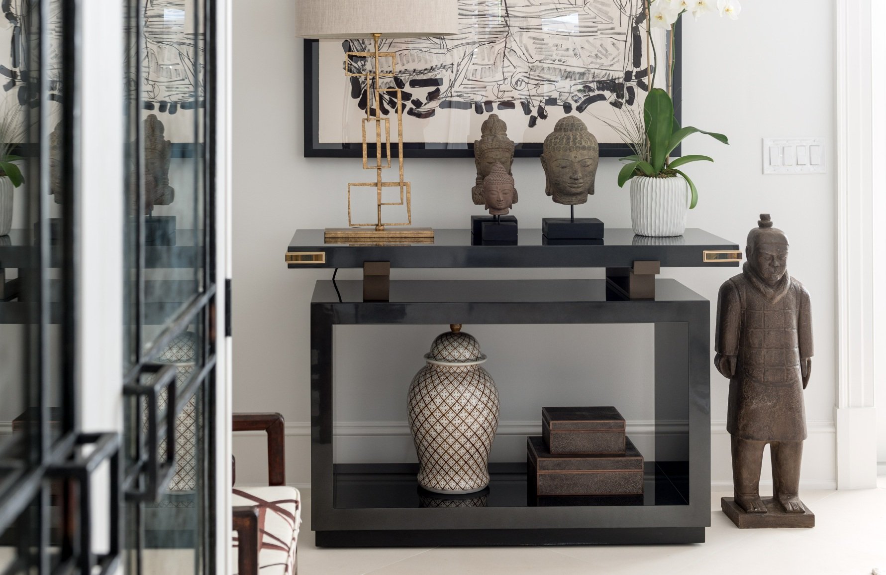 Chinese terracotta inspired decor and other accessories in a dedicated area of the home for displaying decor