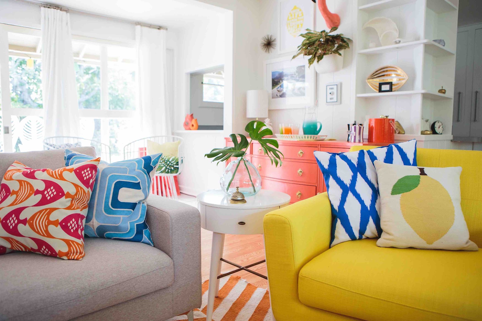Colorful cushion covers and soft throws on sofa promotes the Retro vibe in the space