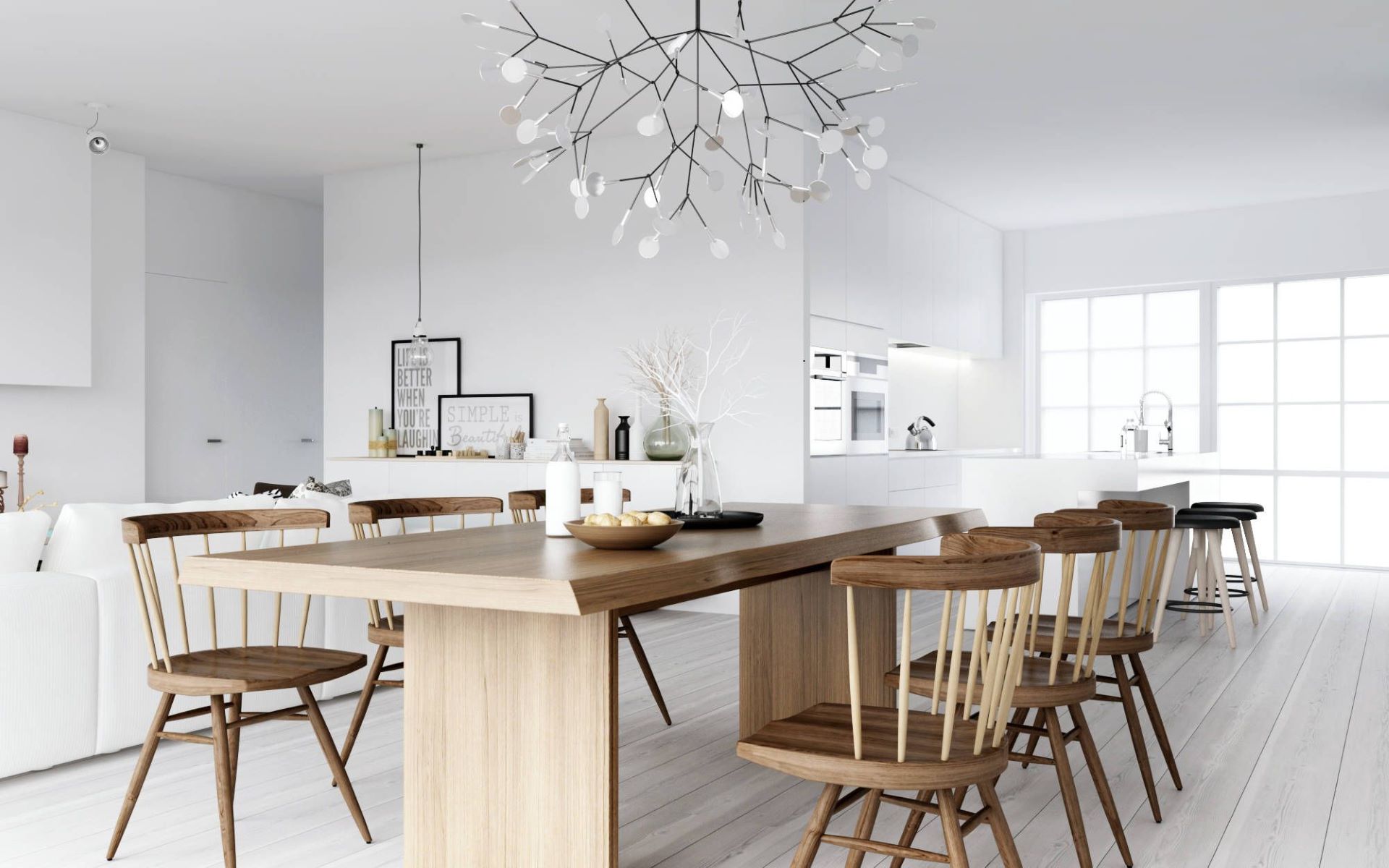 Nordic wooden dining table and chairs contrast with white walls and cabinetry 