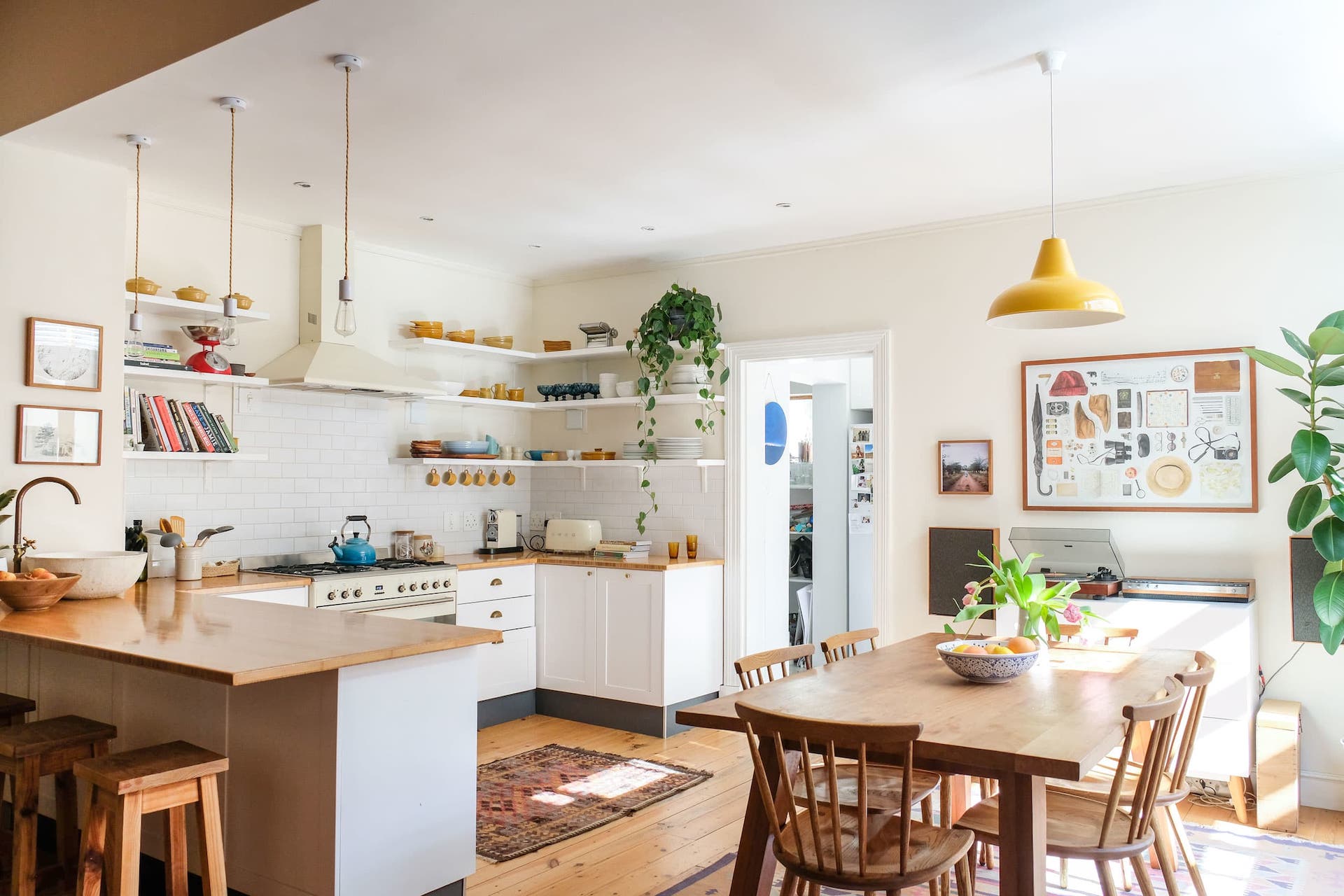 Scandinavian kitchen with warm wood cabinetry and pendant lights