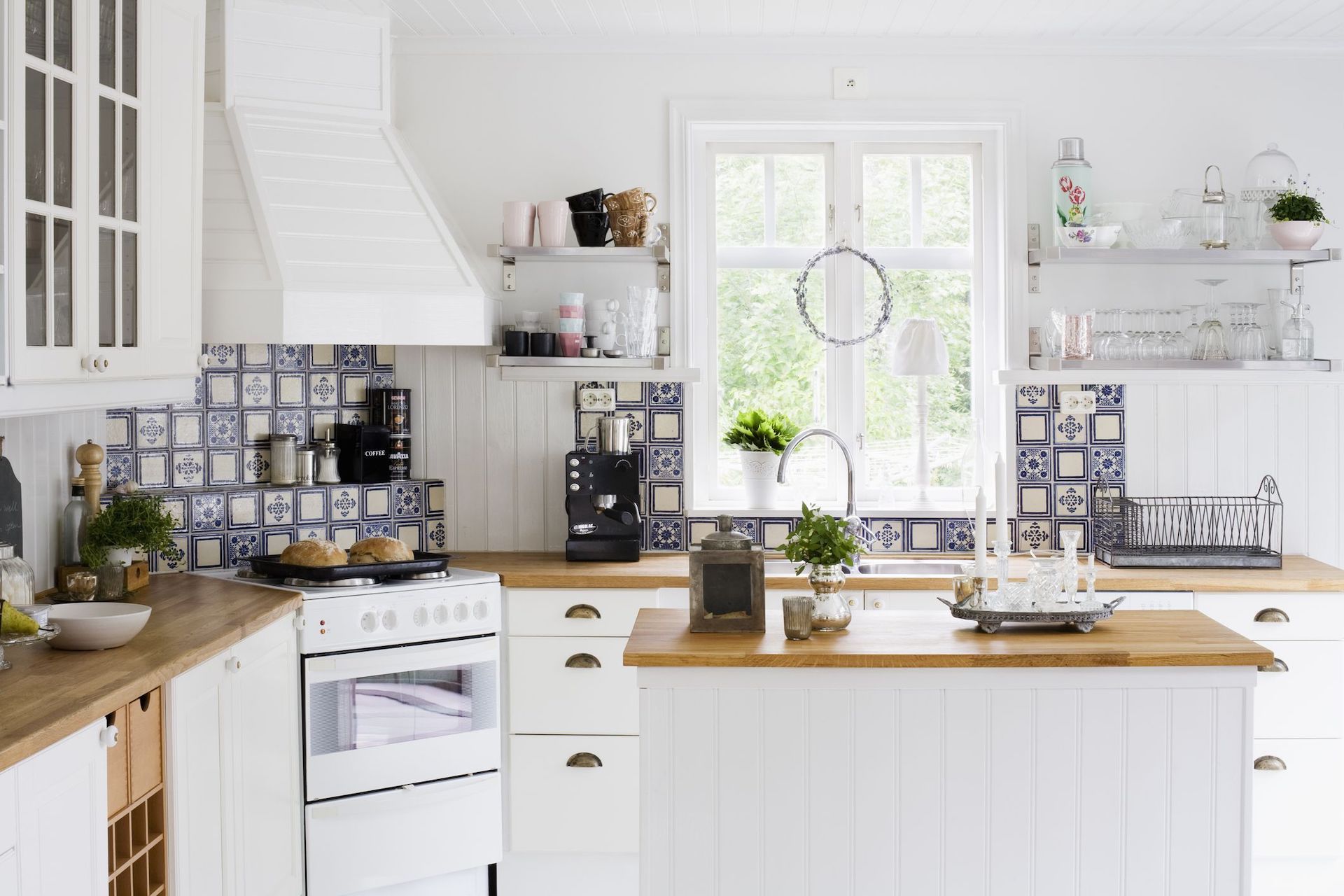 Traditional Spanish backsplash tiles give the Scandinavian kitchen top a textured effect