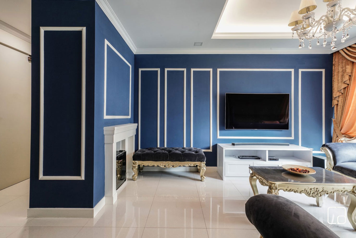 Modern Victorian living room with white wooden frames on blue feature walls.