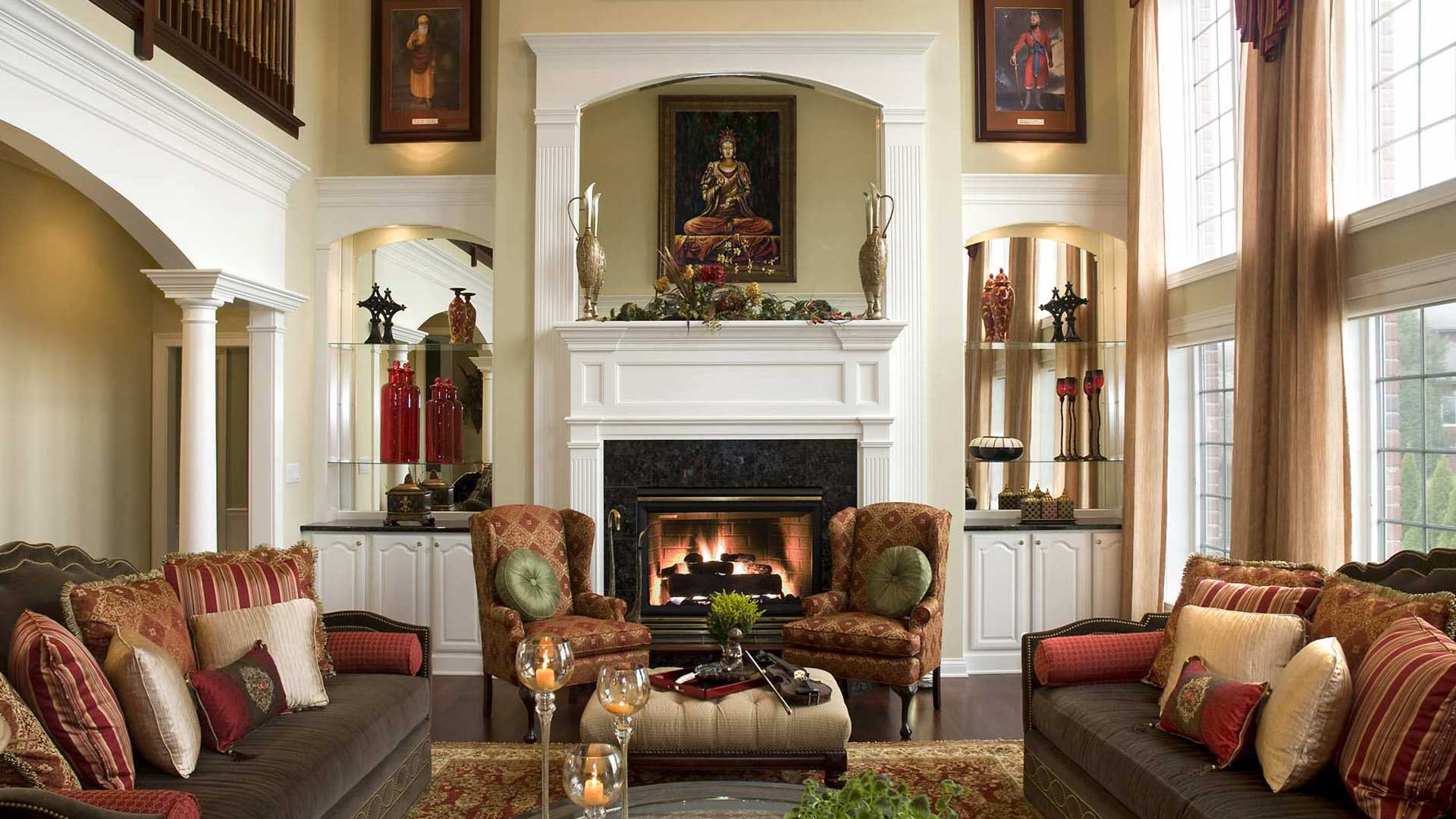 Victorian house sitting room with fabric furniture and  fireplace in the center.