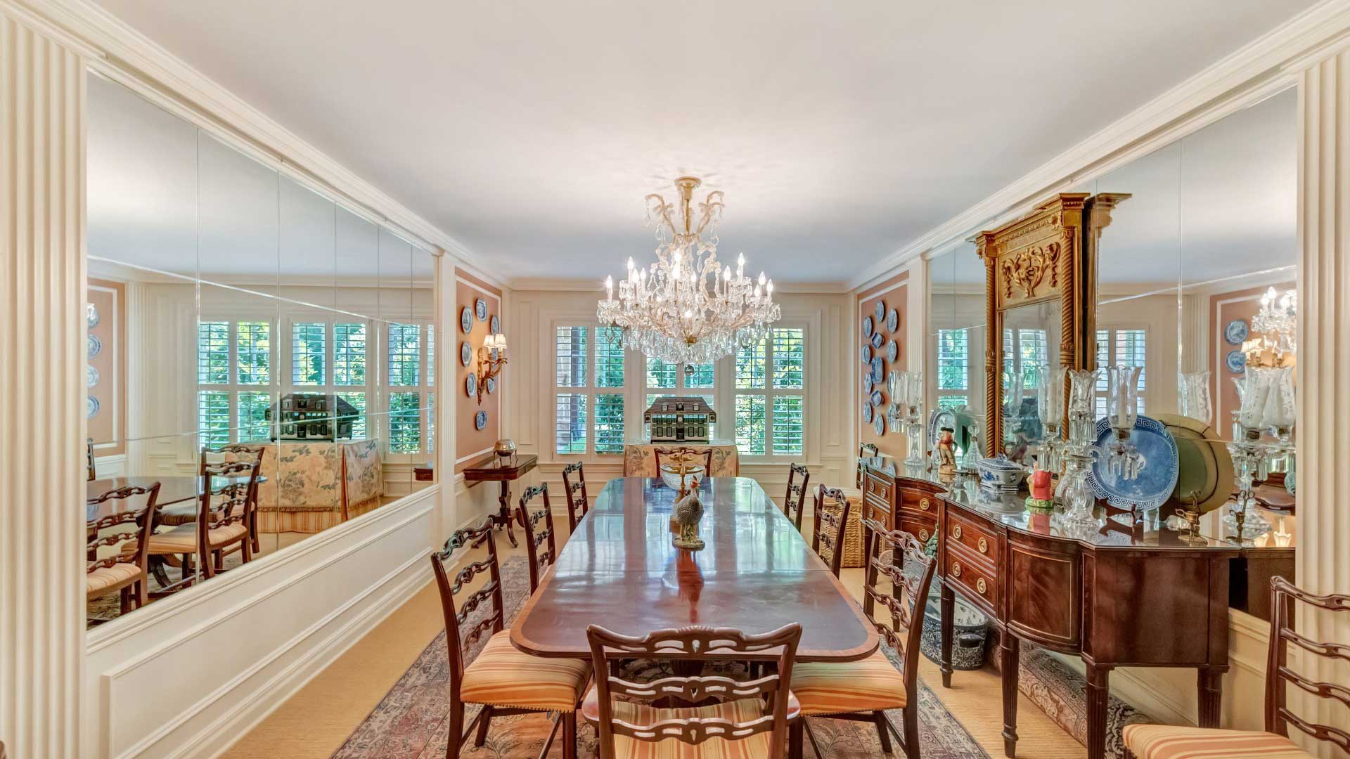 Mirror design dining room with carved wooden dining furniture and side-boards.