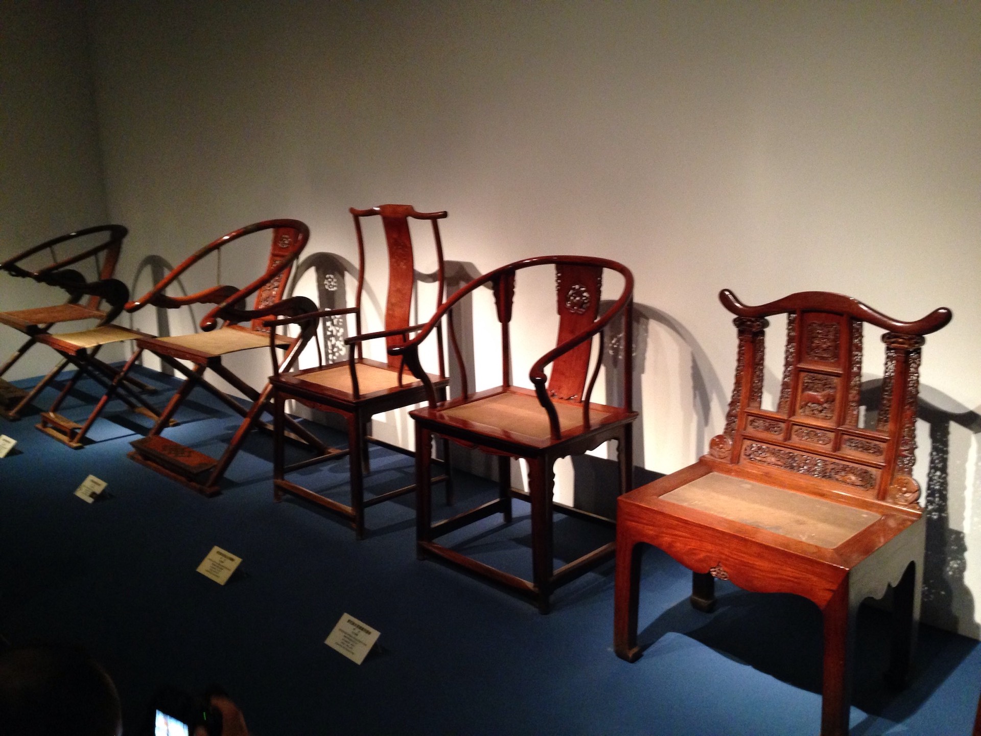 Five traditional Oriental Chinese chairs from Ming Dynasty lined up for display at the Shanghai Museum